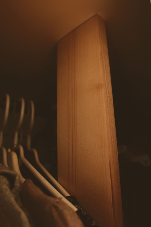 Cluttered closet with overflow and disorganized textiles